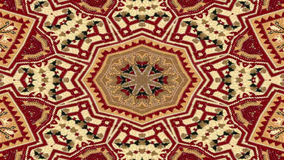 An expert inspecting a vibrant rug on a table, focused on its details and craftsmanship in a bright, organized space