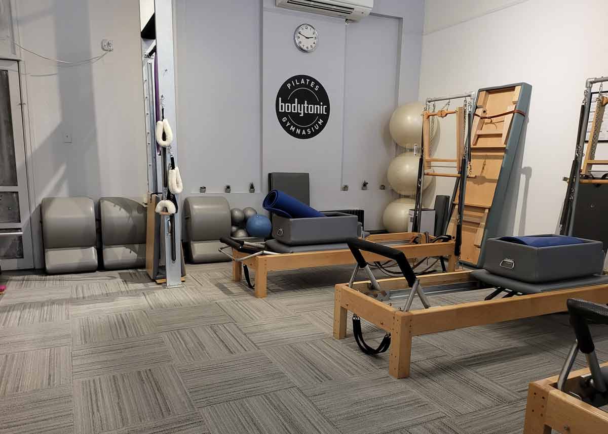 A before-and-after view of a gym carpet, illustrating the successful cleaning process by Megerian Commercial Carpet Cleaners.